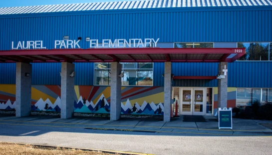 Entrance of Laurel Park Elementary with colorful mural beneath.